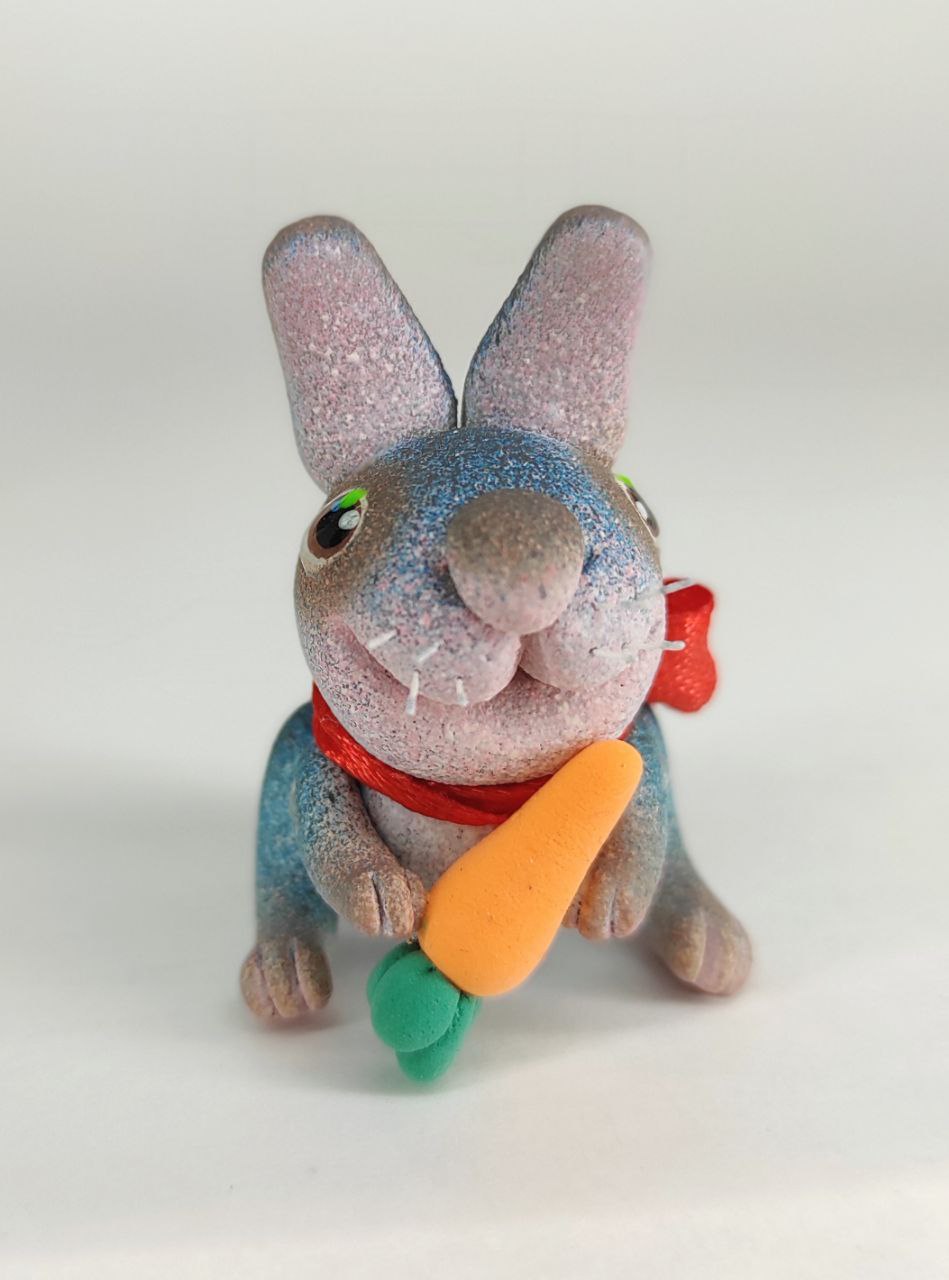 Blue bunny with a carrot. Animal miniature. Rabbit toy. Inspire Uplift
