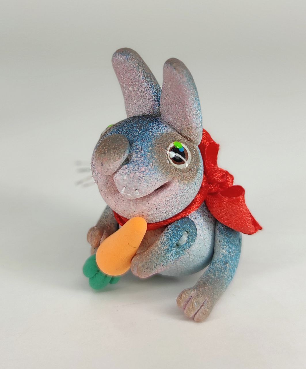 Blue bunny with a carrot. Animal miniature. Rabbit toy. Inspire Uplift