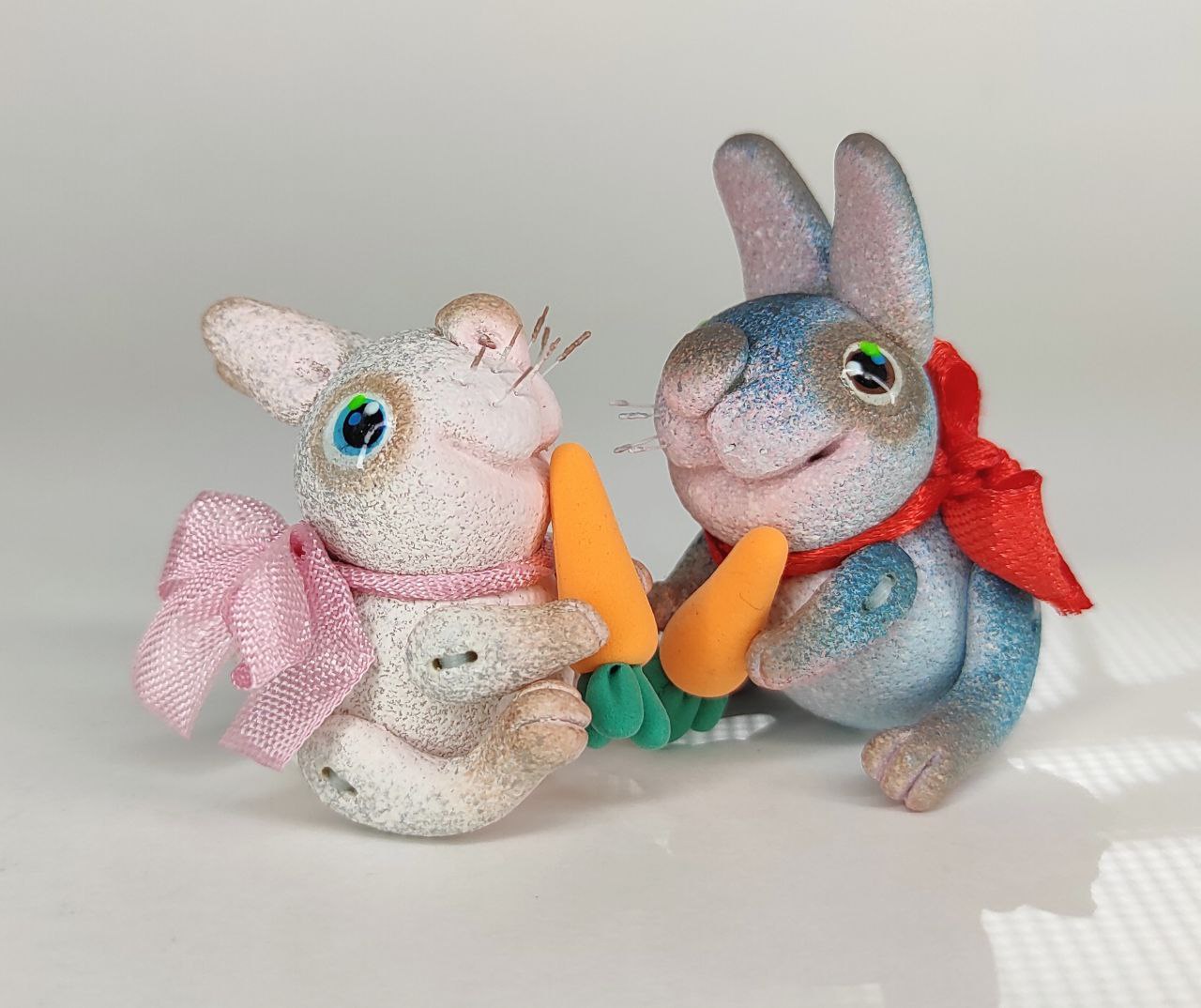 Blue bunny with a carrot. Animal miniature. Rabbit toy. Inspire Uplift