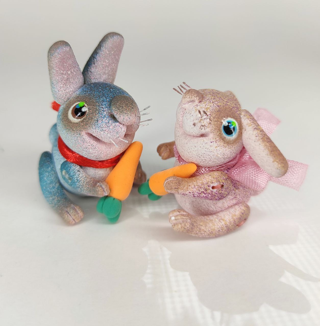 Pink bunny with a carrot. Animal miniature. Rabbit toy. Inspire Uplift