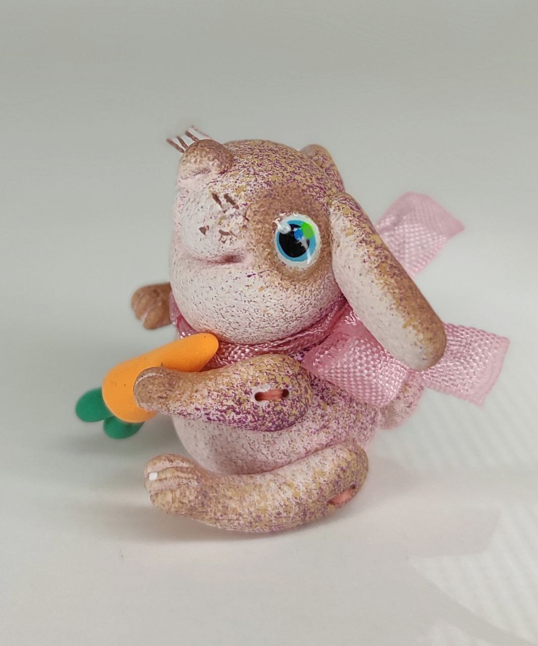 Pink bunny with a carrot. Animal miniature. Rabbit toy. Inspire Uplift