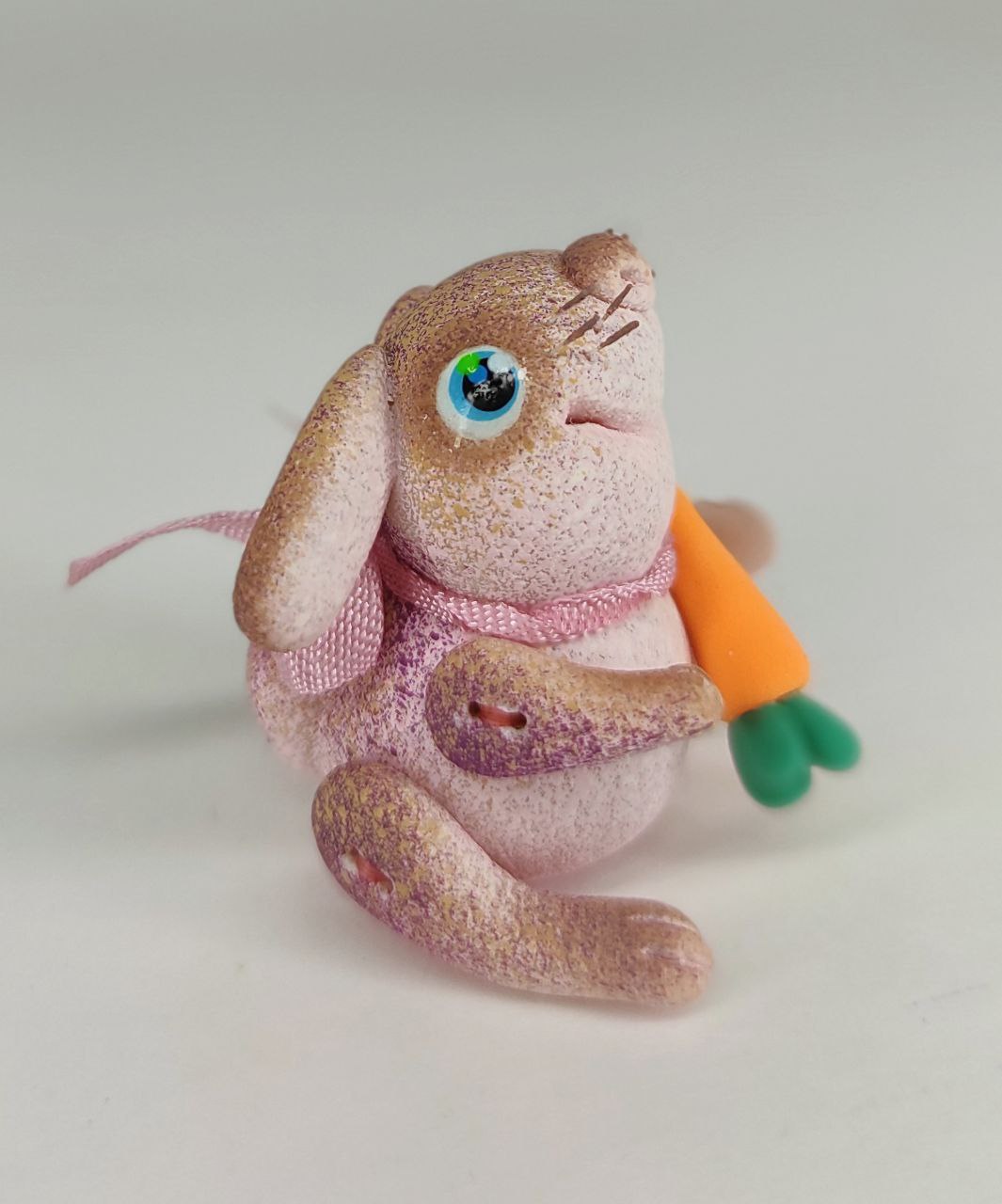 Pink bunny with a carrot. Animal miniature. Rabbit toy. Inspire Uplift